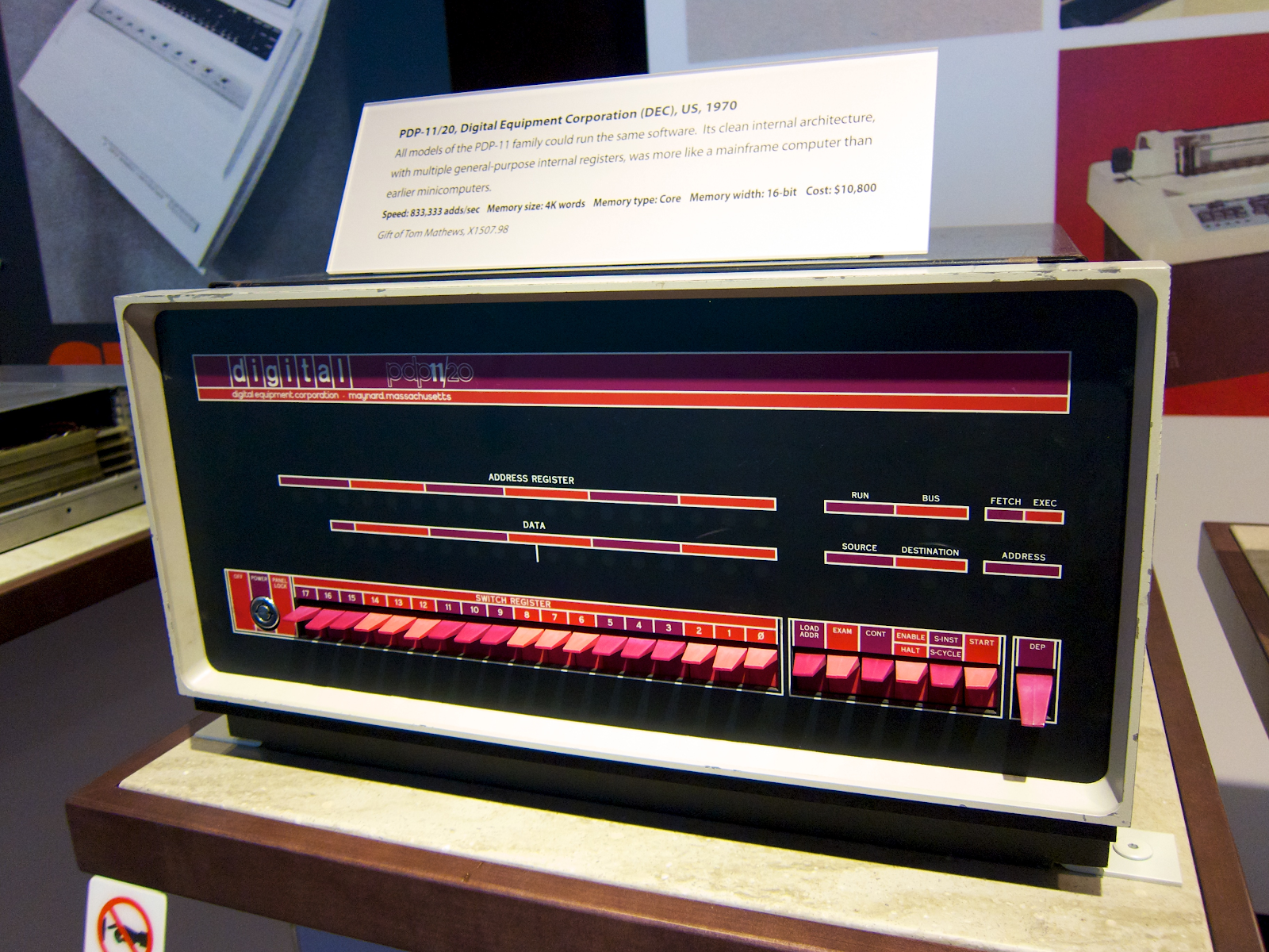 A DEC PDP-11 unit with a cream case prividing a striking contrast to a black front pannel and multicolored off-red switches